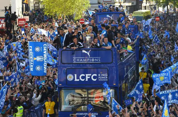 Leicester City's Italian manager Claudio Ranieri (C) stands with the Premier league trophy as the Leicester City team take part in an open-top bus parade through Leicester to celebrate winning the Premier League title on May 16, 2016.  / AFP PHOTO / GLYN KIRKGLYN KIRK/AFP/Getty Images
